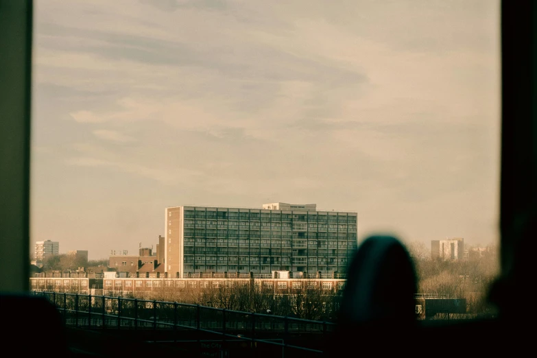 two buildings are seen from across a large window