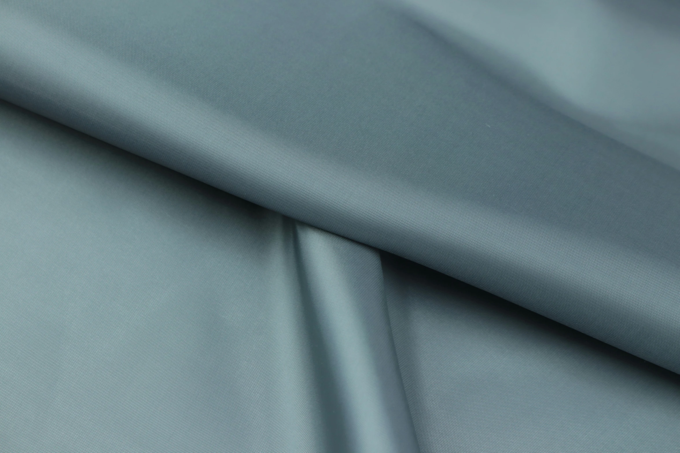 textured satin fabric with an even darker green hue