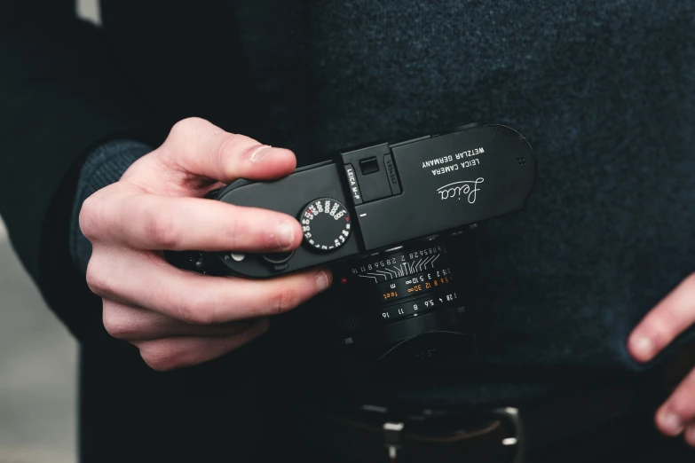 a man holding his phone and the lens