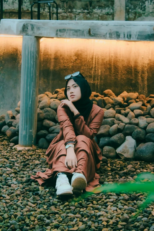 a woman sitting on the ground in a red dress