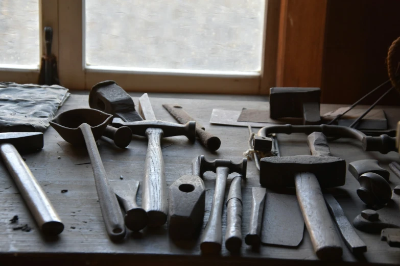 a bunch of wrenches on a wood table