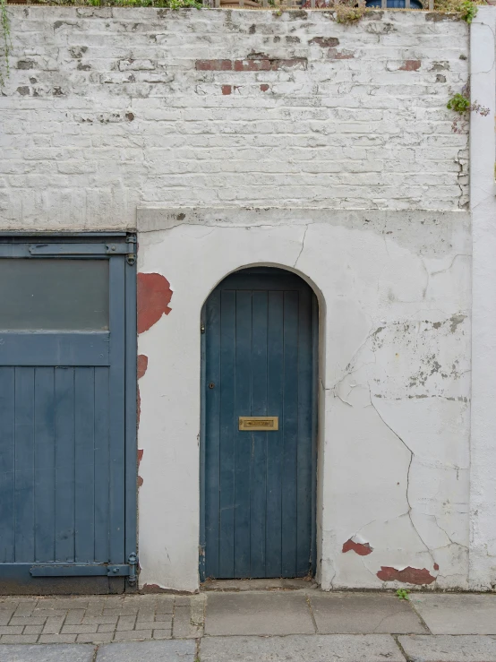 a blue and white door and a white brick wall