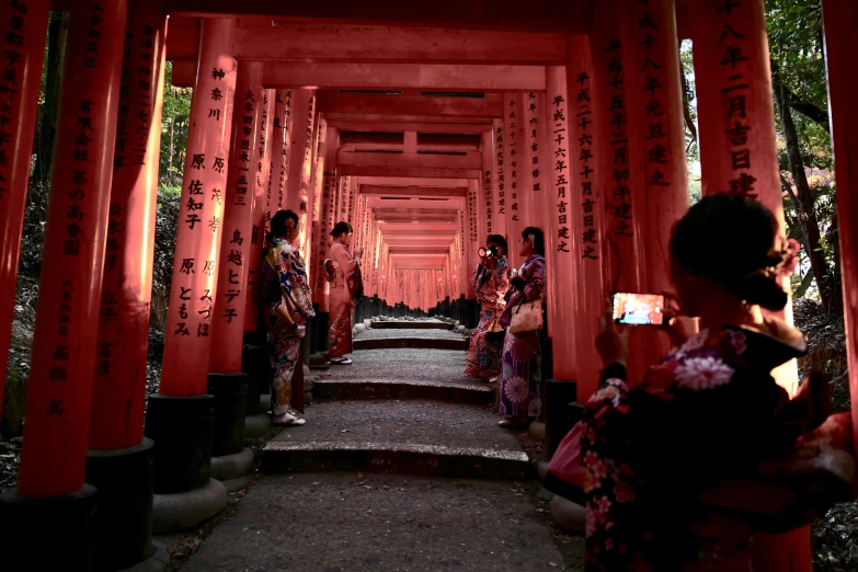 three women walking down a set of stairs next to trees