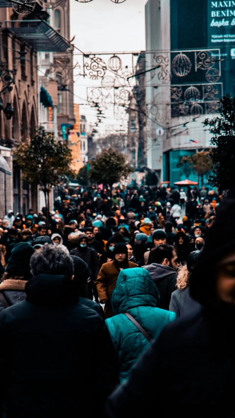 this is a crowd of people walking on a crowded street