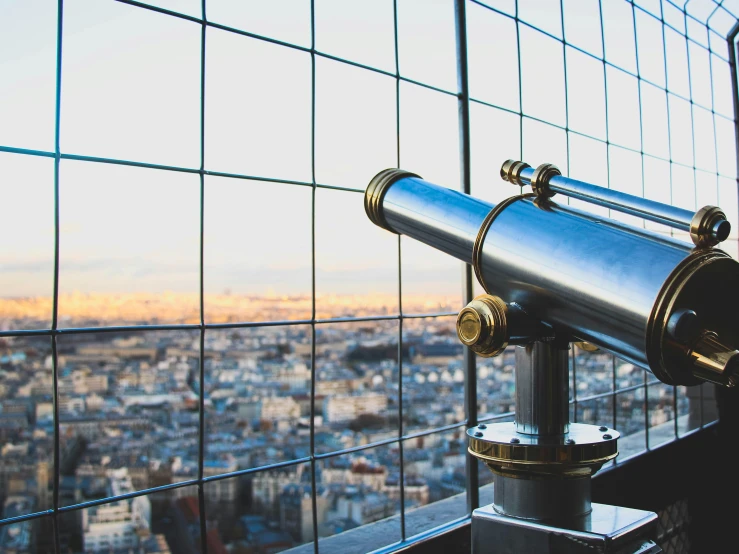 a telescope next to the window on a building