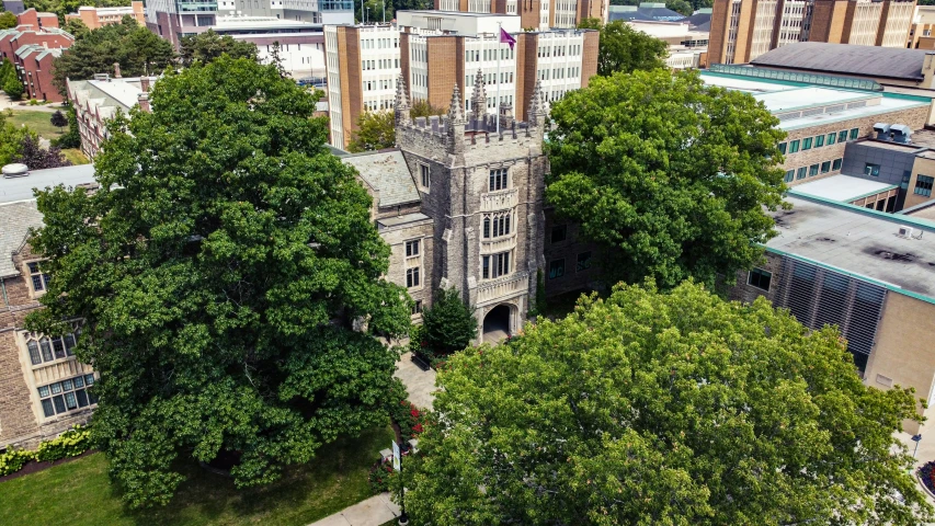 an aerial view of the university with some trees in the foreground