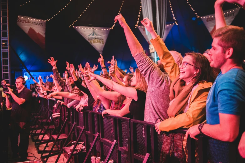 a crowd of people standing on top of a stage