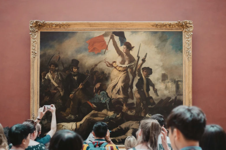 a group of people taking pictures in front of a painting