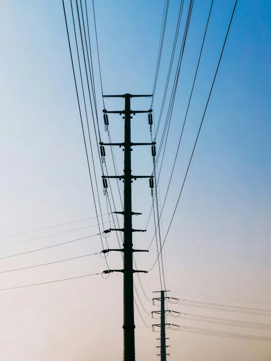 the power lines in the sky with cars driving down it