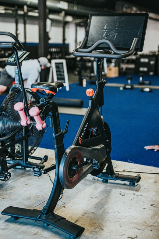 a person uses a stationary bike at a gym