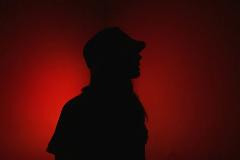 a black person standing in a red room