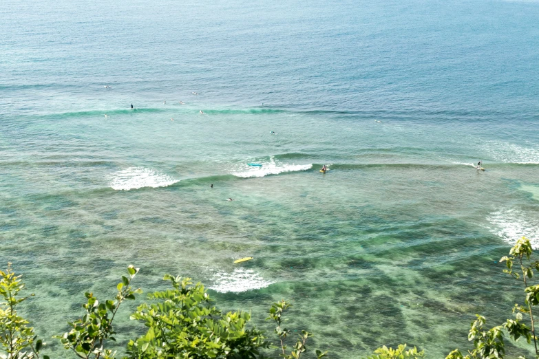 some people surfing in the water with people on them