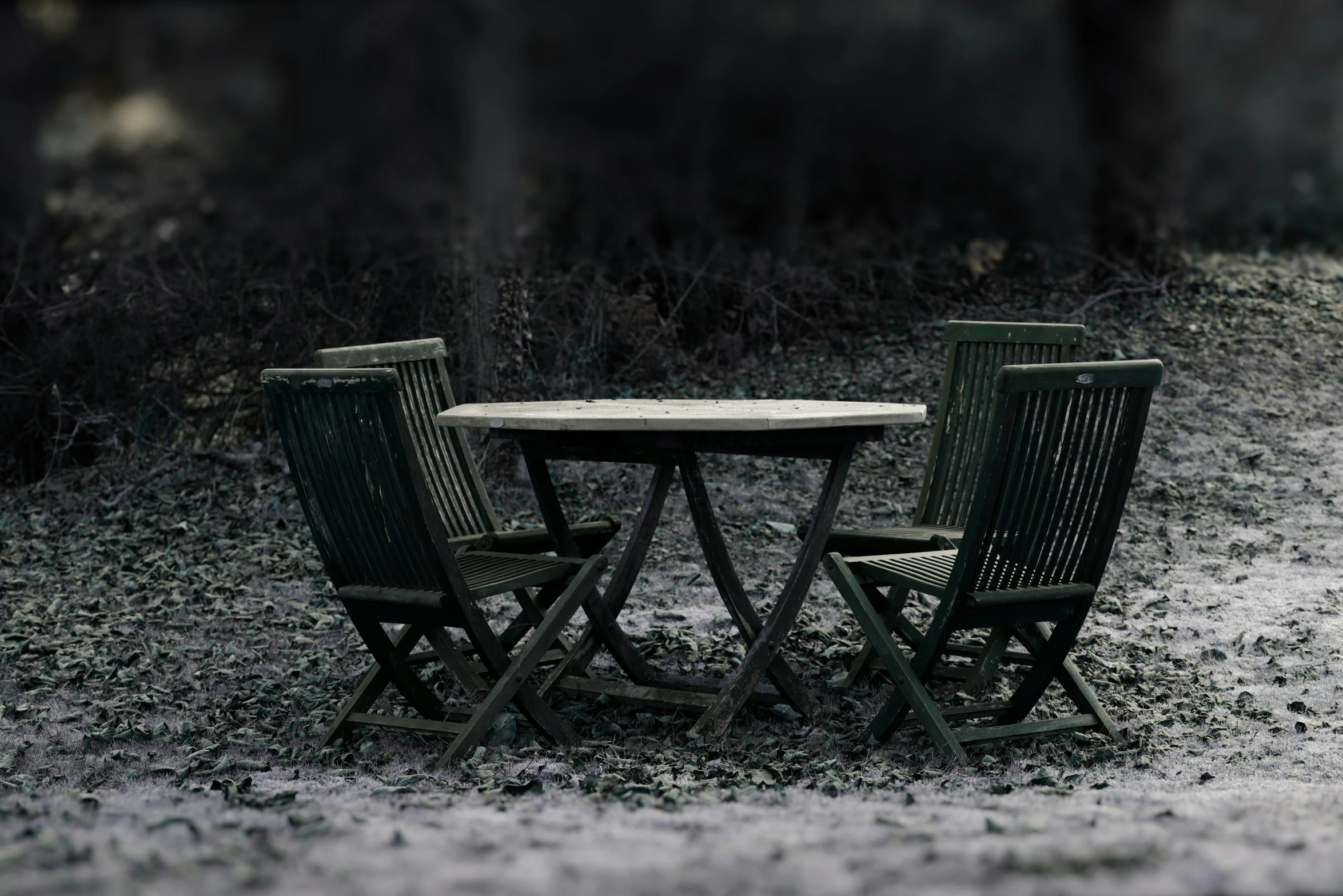 two green chairs sitting at a table with a white table top