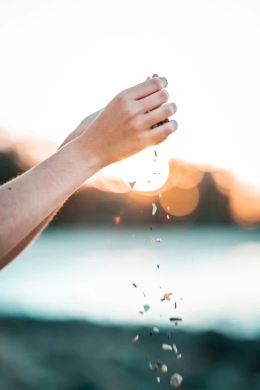 a person's hand holding a piece of food