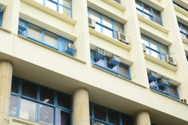 two buildings with some very tall windows and blue shutters