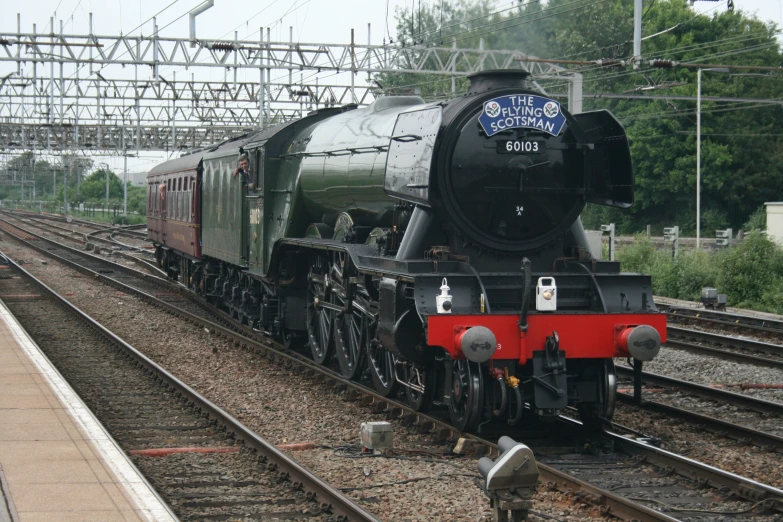 an old fashioned steam engine sits at the station