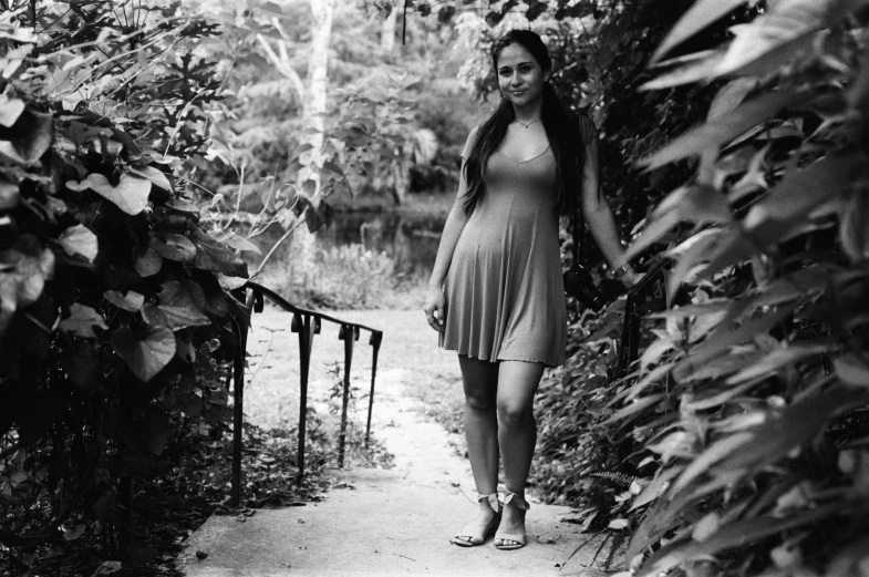 black and white image of a woman walking down a dirt pathway