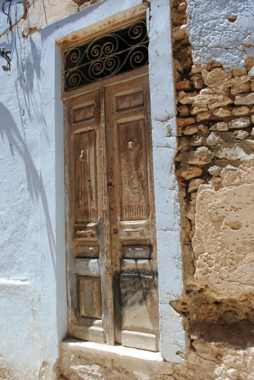 wooden doors with ornate iron design on a stone building