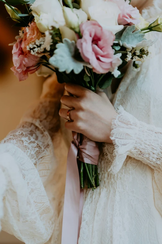 a close up of a woman holding a bouquet of flowers