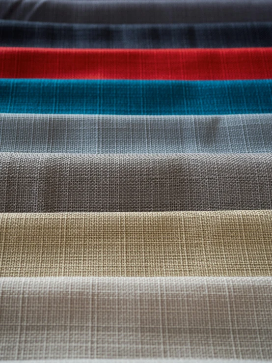 several colors of fabric lined up on a table