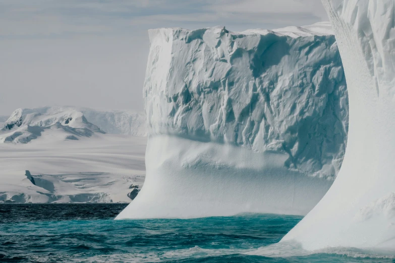 a large iceberg is partially submerged in the water