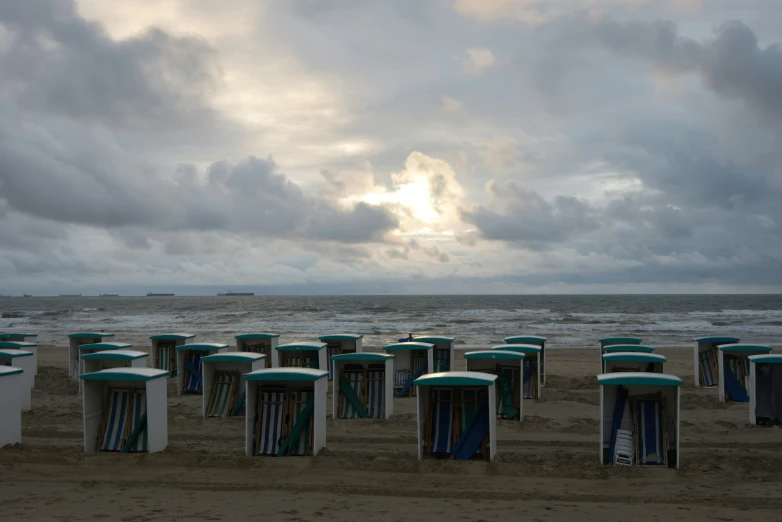 a line of portable toilets on the beach