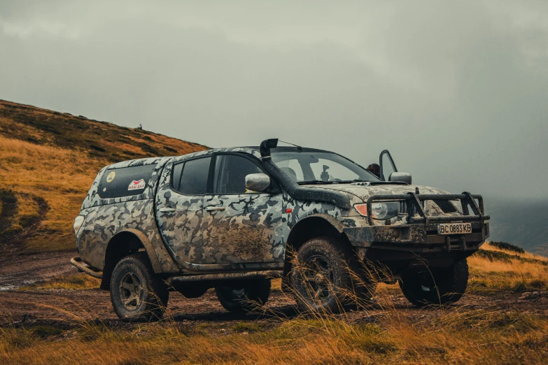 an image of a large truck driving through the grass