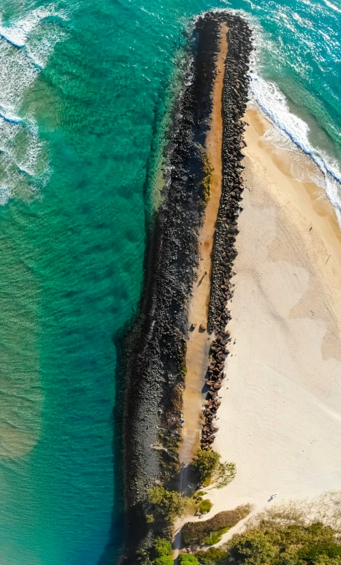 an aerial view of a large long black rock