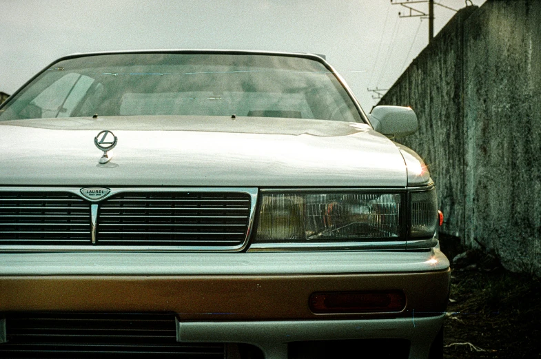 a car parked in front of a wooden fence