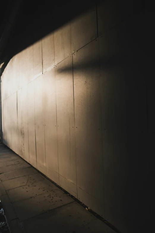 the shadow of a street sign on a wall