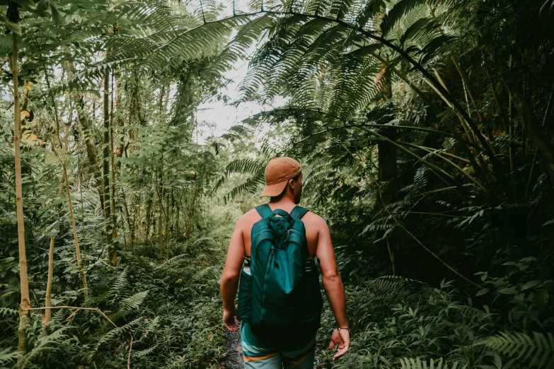 a man walking in the woods wearing backpack