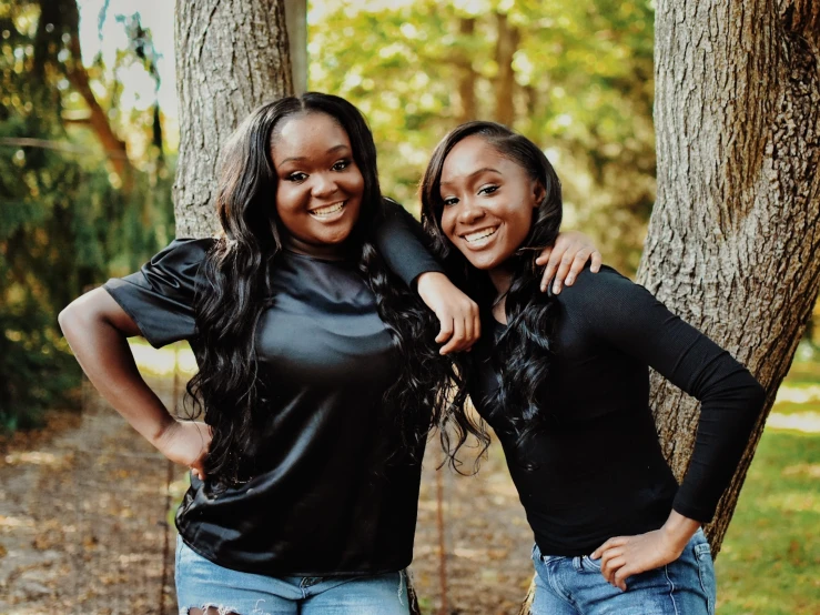 two black women are posing for the camera