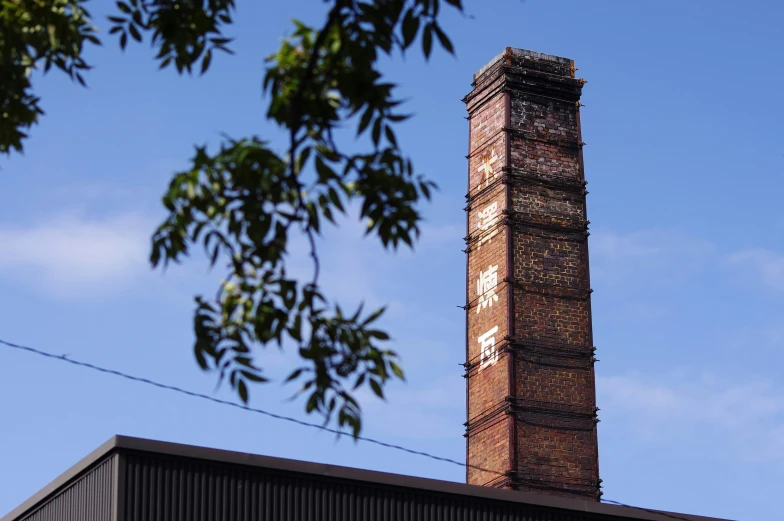 a tower with clocks on the front of it against a blue sky