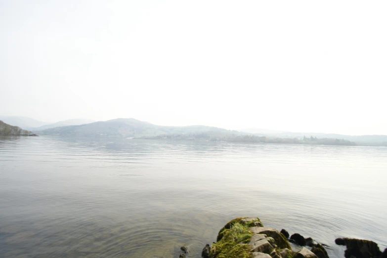 a lake is shown with large rocks in the middle