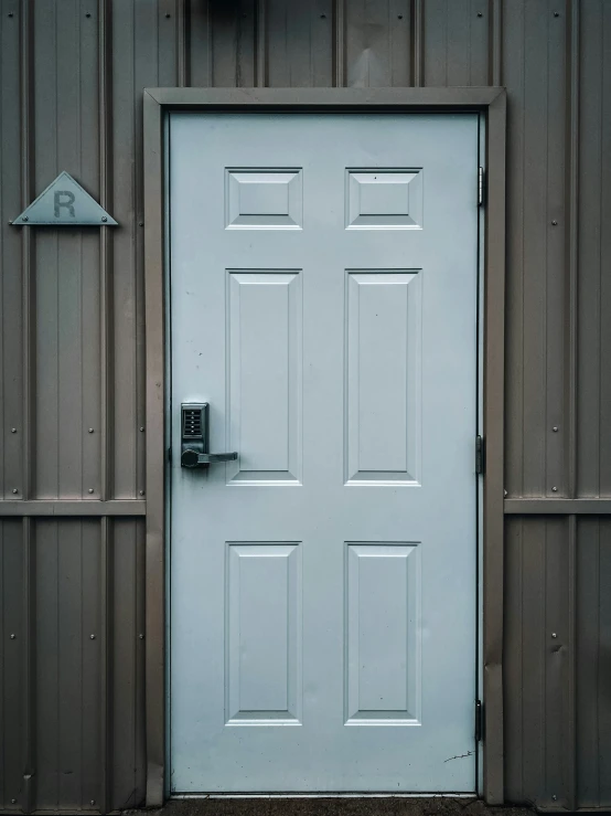 a white door sits in front of a brown wall