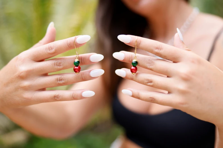 a woman holding onto two rings in her hands