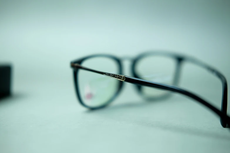 a pair of glasses sits on a surface