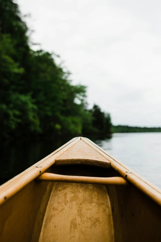 the front end of a boat in a lake