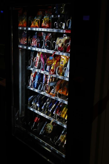 a vending machine in the dark with items inside