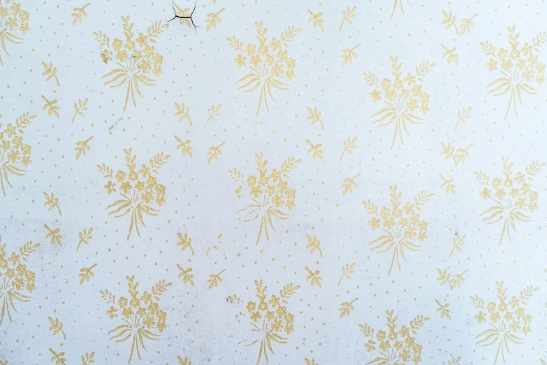 a yellow wallpaper with a flower pattern on it