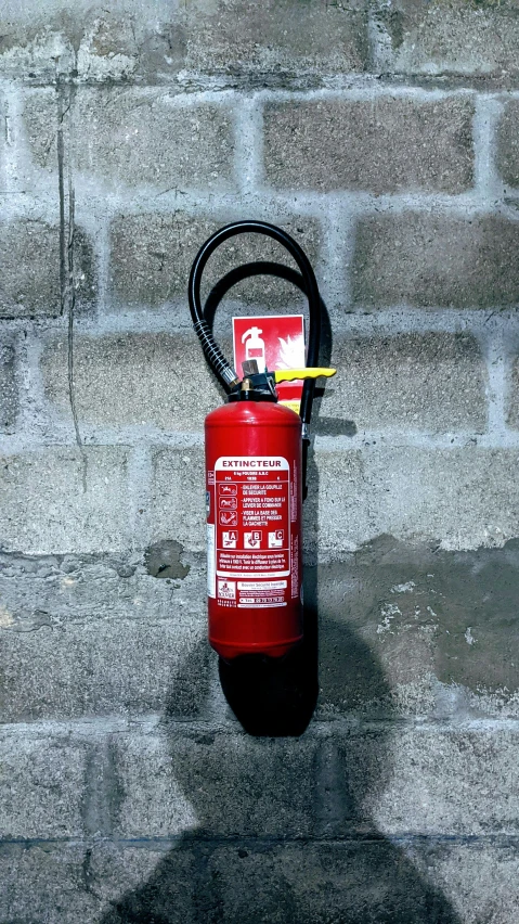 a fire extinguisher has a power cord hooked up to it