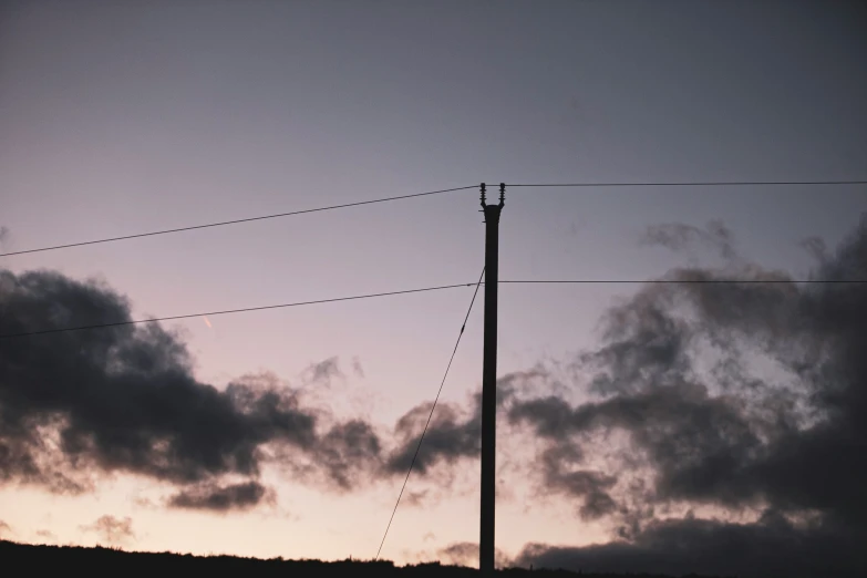 a po with some clouds on it and some power lines in the background