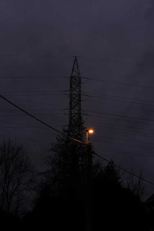 power lines and a tower at night with no one at it