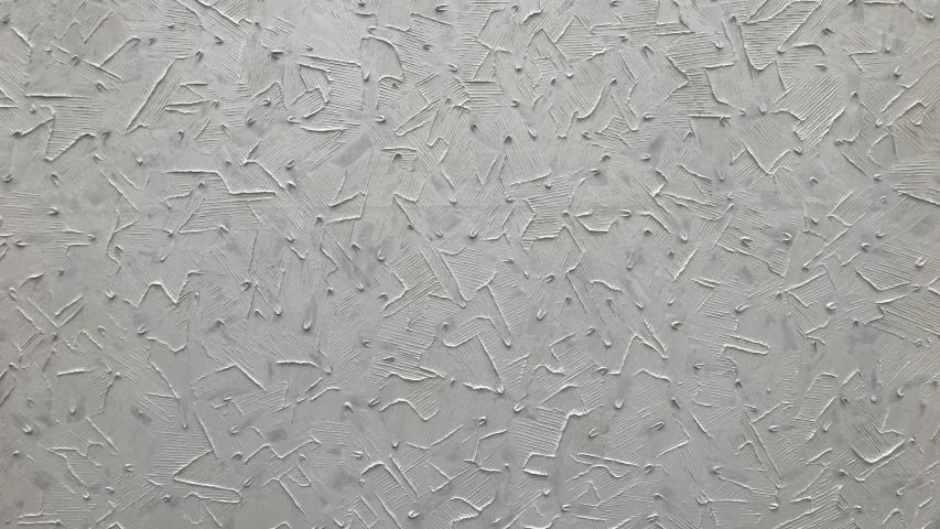 a wall covered in white paint and designs