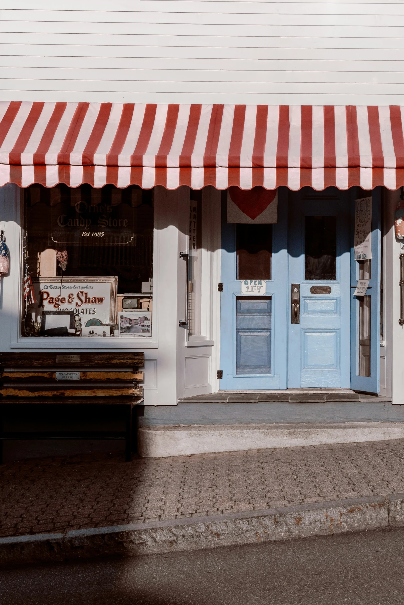 a red white and blue striped awning a shop front