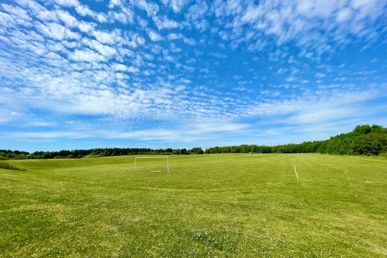 the view from behind a baseball bat on a grass field