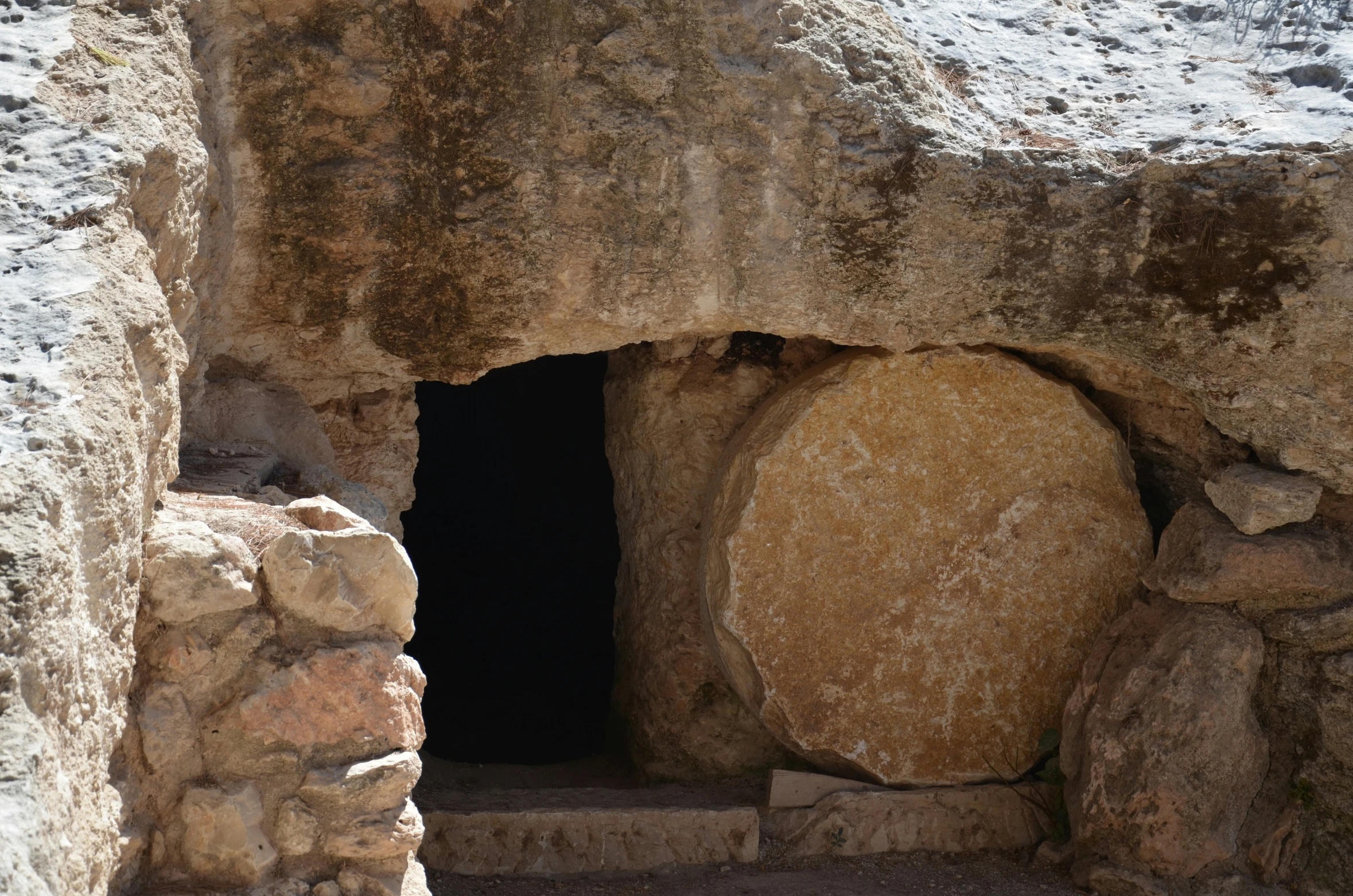 the door is made out of stone by boulders