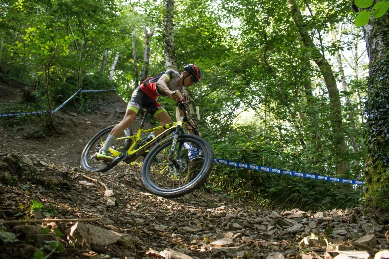 a person riding a mountain bike down a small hill