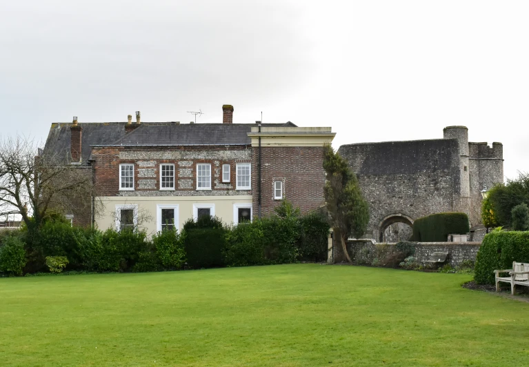 a very large house sitting in the middle of a lush green yard