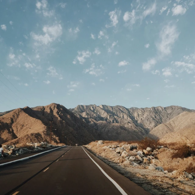 the view from a vehicle driving down a deserted road